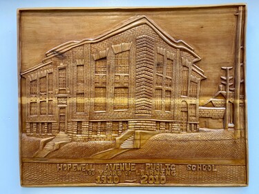 A wooden bas-relief carving of Hopewell Avenue Public School's facade